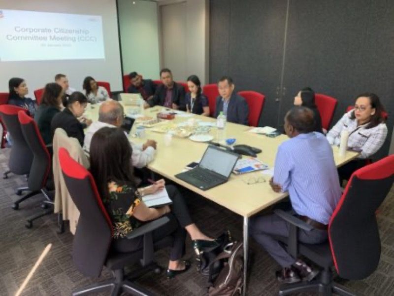 A committee meeting around a boardroom table